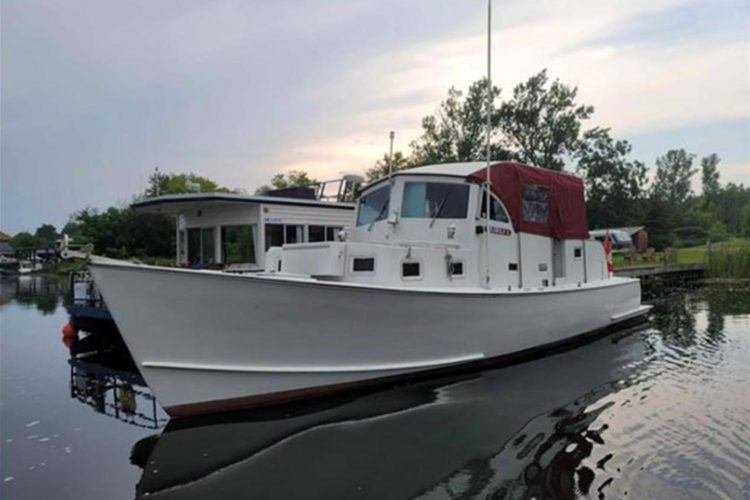 large white boat in the water at a dock